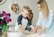 Mother and children enjoying a fun and messy baking session together at home.