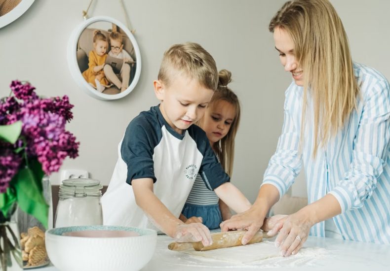 Mother and children enjoying a fun and messy baking session together at home.